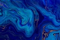 Hand painted background with mixed liquid blue and golden paints. Abstract fluid acrylic painting. Modern art. Marbled