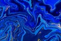 Hand painted background with mixed liquid blue and golden paints. Abstract fluid acrylic painting. Modern art. Marbled Royalty Free Stock Photo