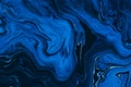 Hand painted background with mixed liquid blue paints. Abstract fluid acrylic painting. Modern art. Marbled blue Royalty Free Stock Photo