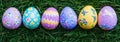 Hand-painted, colorful Easter eggs scattered on the grass. Banner displaying a panoramic view Royalty Free Stock Photo