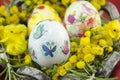 Hand painted decoupage Easter egg in a basket Royalty Free Stock Photo