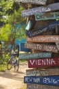 Hand painted direction wood signs to different cities of the world, Laos Royalty Free Stock Photo