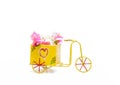A hand-painted distressed-looking rustic tricycle with flowers