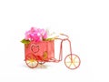 A hand-painted distressed-looking rustic tricycle with flowers