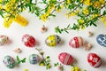 Hand-painted Easter eggs in patterns seen from above on a white background.