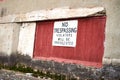 No trespassing sign on an abandoned building