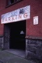 Old parking sign painted over door of building Royalty Free Stock Photo