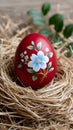 Hand-painted red Easter egg resting in a nest Royalty Free Stock Photo