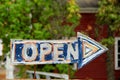 Hand painted sign that reads 'open'