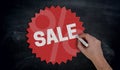 Hand paints with chalk Sale on blackboard Concept Royalty Free Stock Photo