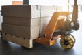 Hand pallet truck with cargo box on pallet rack. Shipment, Manufacturing and warehousing logistics Royalty Free Stock Photo