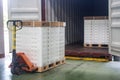 Hand pallet truck loading shipping boxes and goods on wooden pallet at loading dock from container.Soft focus Royalty Free Stock Photo