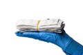 Hand or palm of a doctor in classic medical gloves holds out packs or blisters of pills. White isolated background