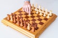 Hand with pawn makes first move on chess Board Royalty Free Stock Photo