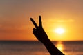 Hand with peace sign sunset background Royalty Free Stock Photo