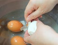 Hand Peeling Boiled Eggs in A Bowl