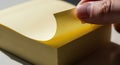 Hand Peeling Yellow Sticky Note from Stack, Blank Post-it for Reminder, Organization, To-Do List, Copy Space Royalty Free Stock Photo