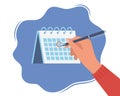 Hand with pen and calendar. Person draws red mark around a date in the calendar. Desktop calendar with a marked date. Mark