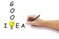 Hand with pen drawing big yellow light bulb with Good idea word Royalty Free Stock Photo