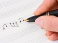 Hand with pen and music sheet Royalty Free Stock Photo