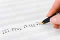 Hand with pen and music sheet Royalty Free Stock Photo