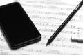 Hand With Pen And Music Sheet - Musical Background Royalty Free Stock Photo