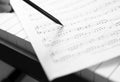 Hand With Pen And Music Sheet - Musical Background Royalty Free Stock Photo