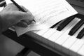 Hand With Pen And Music Sheet - Musical Background Royalty Free Stock Photo