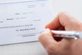 Hand with pen over checkbook Royalty Free Stock Photo