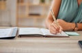 Hand, pen and writing in a notebook with a business woman sitting at a desk in her office for planning. Agenda, schedule Royalty Free Stock Photo