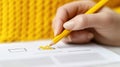 Hand with pencil checks box. Yellow tick mark indicates selection. Task completion survey response. Person possibly filling out