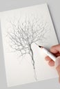 Hand with pencil drawing neuron connections