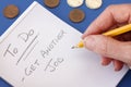 Hand with Pencil making note to Get Another Job