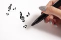 Hand With Pencil And Music Notes Royalty Free Stock Photo