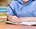 Hand with pencil writing in a notebook Royalty Free Stock Photo