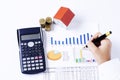 Hand people holding fountain pen on business chart and calculator with coins stack and house paper for loans concept Royalty Free Stock Photo