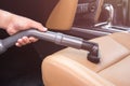 Hand of people holding vacuum cleaner and cleaning inside the SUV car Royalty Free Stock Photo