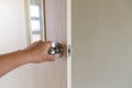 The hand of people open the door to inside ,outside door open putting into front door Royalty Free Stock Photo