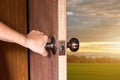 Hand of people open the door to inside ,outside door open putting into front door Royalty Free Stock Photo