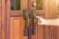 Hand of people open the door to inside ,outside door open putting into front door Royalty Free Stock Photo