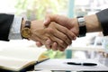 Hand of people shake hand make a deal on a business together in his office.working assemble corporate meeting show symbol join