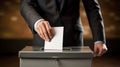 Hand of a person casting vote into the ballot box during elections Royalty Free Stock Photo