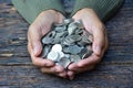 Hand of person holding stack coins on old bark background for sa Royalty Free Stock Photo