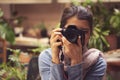 The hand of the person taking the picture of flowers on the camera.