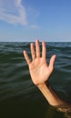 hand of the person who drowns in the sea Royalty Free Stock Photo