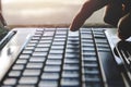 Hand person working and using on a laptop computer for a freelance working with closeup finger an input keyboard for online