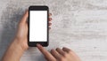 Hand and phone on wooden background