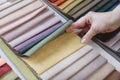 Hand pick the colorful upholstery samples in the shop Royalty Free Stock Photo