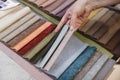 Hand pick the colorful upholstery samples in the shop Royalty Free Stock Photo