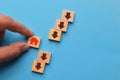 Hand picked home icon with an arrow down on wooden blocks. The fall and crisis of the real estate market Royalty Free Stock Photo